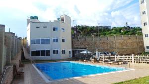 a large swimming pool in front of a building at 3 Bed Luxury Condo in Lubowa in Kampala