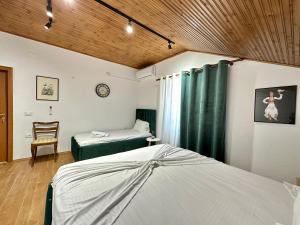 a bedroom with two beds and a chair in it at Lakeview Escape Koman in Koman
