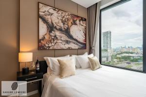 a bedroom with a large bed with a large window at Sarene Lumiere Riverside Thao Dien in Ho Chi Minh City +64 photos