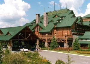 a large wooden building with a green roof at Disney's Wilderness Lodge in Orlando