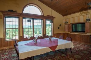 a large room with a table and chairs and windows at Jiminy Peak Mountain Resort in Hancock