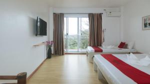 a hotel room with two beds and a window at RedDoorz at Garvs Boutique Hotel Boracay in Boracay