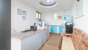 a kitchen with a counter and a refrigerator at RedDoorz at Garvs Boutique Hotel Boracay in Boracay