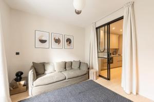 a white living room with a couch and a window at L'ATELIER 2 - Vintage KEYWEEK downtown Biarritz Centre in Biarritz