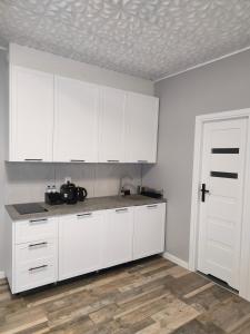 a kitchen with white cabinets and a white door at 722 Slate Apartament Jedlina-Zdrój in Jedlina-Zdrój +27 photos
