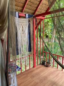 a porch of a tent with a net at Presente in Ko Phayam