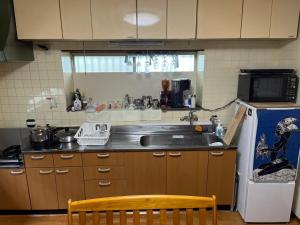 a kitchen with a sink and a refrigerator at Kajikaen - Vacation STAY 57948v in Kawazu +13 photos