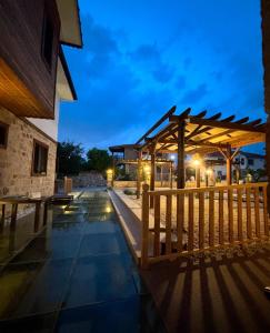 a night view of a building with a wooden fence at Orya Butik Otel in Side