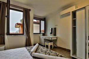 a bedroom with a bed and a desk and a window at Orya Butik Otel in Side