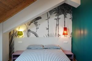 a bedroom with a bed with a mural of palm trees at Terrazza 72 - Deluxe Room & Breakfast in Agerola