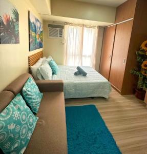 Ένα ή περισσότερα κρεβάτια σε δωμάτιο στο Avida Towers Riala It Park +13 φωτογραφίες