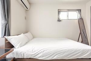 Letto o letti in una camera di アンドステイ竹ノ塚201