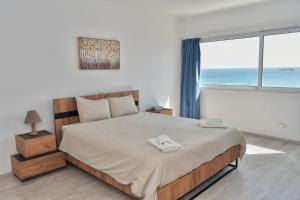 Postel nebo postele na pokoji v ubytování Stunning Top-Floor Beachfront Apartment