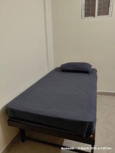 a bed in a room with a black mattress at Adithya Inn Lodge in Jadcherla