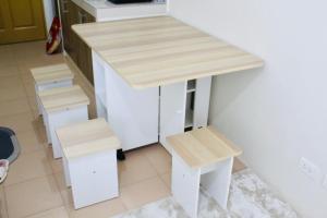 a small kitchen with a counter and two stools at Perfect Staycation in Duma -Marina Spatial Condo in Dumaguete