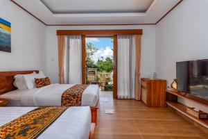 Postel nebo postele na pokoji v ubytování Uma Nandhi Villa Ubud