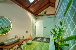 a bathroom with a sink and a mirror at Munjoh Ocean Resort - Private Beachfront Luxury Retreat in Havelock in Havelock Island