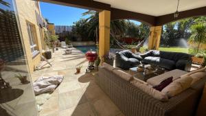a living room with couches and a patio at Sunset Retreat in Cape Town