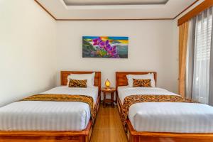 Postel nebo postele na pokoji v ubytování Uma Nandhi Villa Ubud