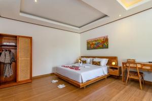Postel nebo postele na pokoji v ubytování Uma Nandhi Villa Ubud