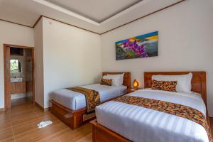 Postel nebo postele na pokoji v ubytování Uma Nandhi Villa Ubud