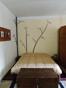 a bedroom with a bed with a painting on the wall at Oriente Dell'Etna in Belpasso