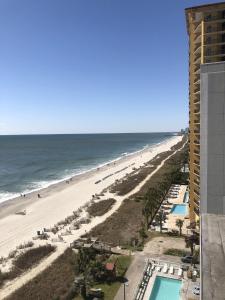 a view of the beach from the balcony of a resort at Blue Palmetto Vacation Rentals in Myrtle Beach