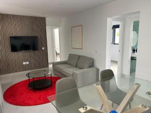 a living room with a glass table and a couch at Villa Marismas in Barbate