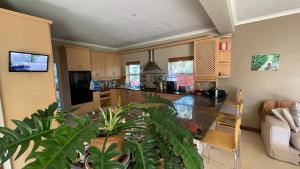 a kitchen and living room with a couch and a table at Sunset Retreat in Cape Town