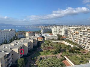 an aerial view of a city with buildings and the ocean at Appartement Mimosa Croisette in Cannes