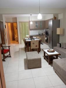 a kitchen and living room with a table and a couch at Nea Peramos Breeze in Nea Peramos +16 photos