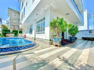 a house with a swimming pool in front of a building at Serina Villa Pool Beach in Vung Tau