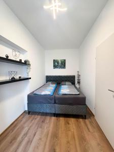 a bedroom with a bed and a wooden floor at Cozy Apartments in Central Location with Free Parking on Availability in Vienna