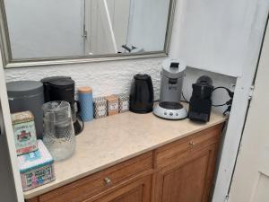 a kitchen counter with appliances sitting on top of it at Little Beach House - Free parking in Zandvoort