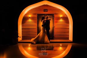 a bride and groom standing in front of a door at Pencoed House Estate (Cardiff) in Cardiff