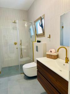 a bathroom with a shower and a toilet and a sink at מול ים המלח in Ovnat