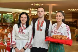 a man and two women holding a tray of food at Les Magnolias Hotel in Primorsko +30 photos