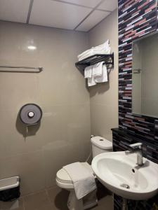 a bathroom with a white toilet and a sink at ณัฐพิมลเพลส์ 3 in Bangkok Yai
