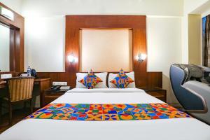 a hotel room with a bed and a desk at FabHotel Shubhangan - Nr Bandra in Mumbai