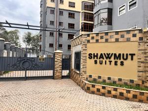 a sign for shawmut suites on the side of a building at Nakuru CBD Luxury Suites With Heated Pool, GYM, Secure Parking in Nakuru