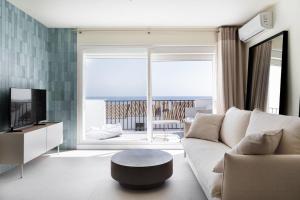 a living room with a couch and a large window at Casa Lola in Sitio de Calahonda