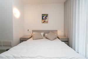 a bedroom with a large white bed with two pillows at IseoLakeRental - Casa Marcellino in Clusane sul Lago +17 photos