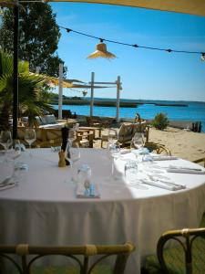 a table with wine glasses on the beach at Hôtel Latécoère in Biscarrosse +54 photos