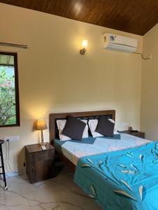 a bedroom with two beds and a window at Cute Studio at Portuguese Villa by Goaround Homes in Anjuna