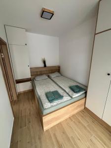 um pequeno quarto com uma cama em um quarto em Apartmani Planina Divčibare em Divčibare