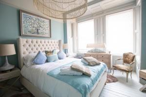 a bedroom with a large bed with blue walls at Vale House, Belvoir Castle in Grantham