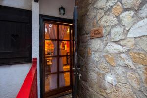 a door to a building with a sign on it at Dandy Villas Agoriani-Chalet Orelia-Fireplace in Eptalofos