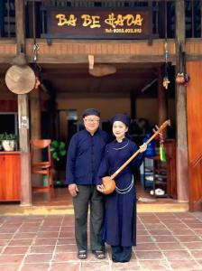 a man and a woman dressed in graduation at Ba Bể Hada Homestay in Ba Be