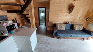 a living room with a blue couch and a table at Green Kub in Slănic-Moldova
