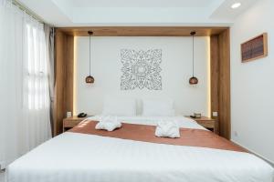 Voodi või voodid majutusasutuse Botum Domrey Hotel toas